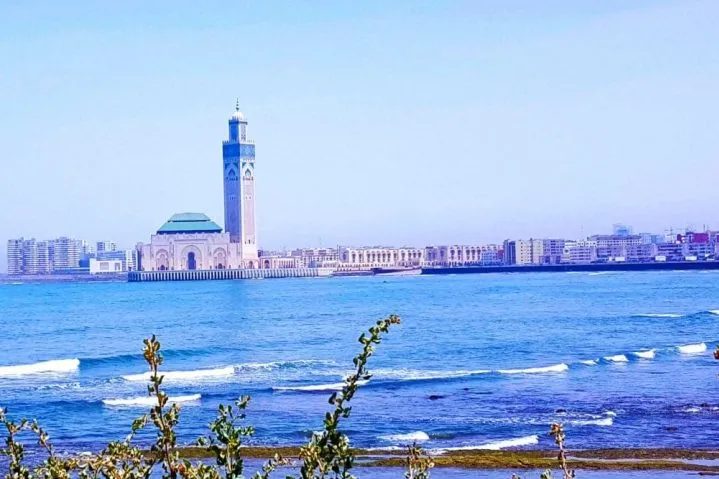 A scenic view of the ocean with a tall tower, highlighting the Casablanca Cruise Excursion experience.
Casablanca Cruise Excursion