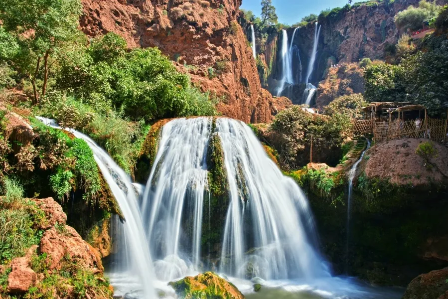 A stunning waterfall cascading in a desert landscape, showcasing the contrast between water and arid surroundings. casablanca to ouzoud falls