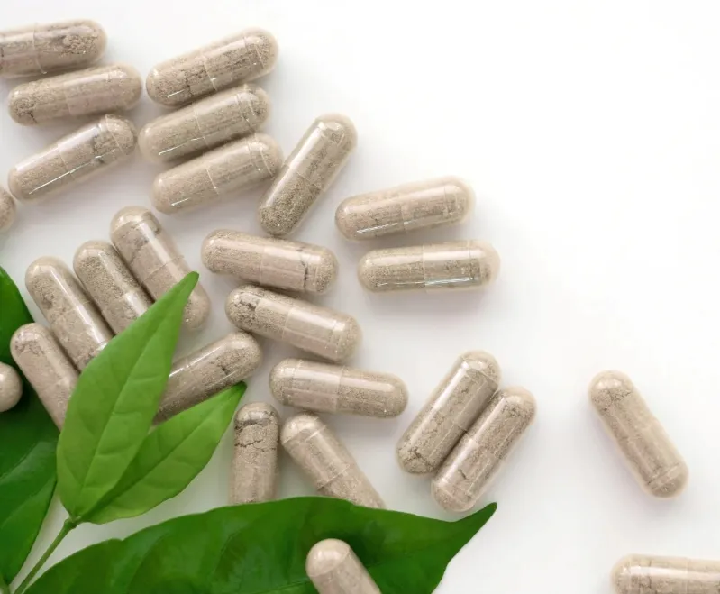 A pile of colorful pills topped with a green leaf, symbolizing the health benefits of Moroccan tea.