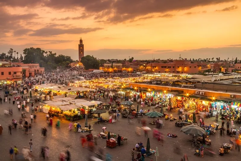 Sunset over Marrakech, showcasing vibrant colors and the city's iconic architecture, ideal for student trips to Morocco.