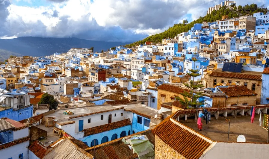 Scenic view of Chefchaouen, Morocco, showcasing its iconic blue buildings and mountainous backdrop on a luxury tour.