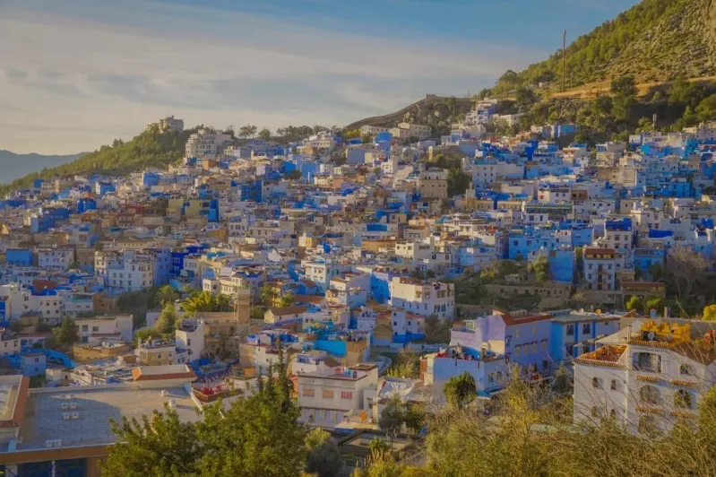Scenic view of Chefchaouen, Morocco, showcasing its iconic blue buildings and mountainous backdrop.