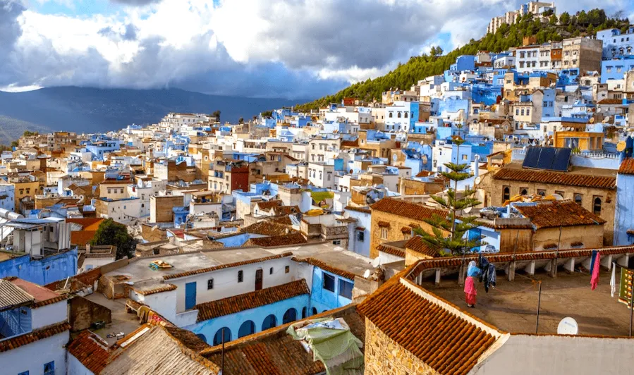 Scenic view of Chefchaouen, Morocco, showcasing its iconic blue buildings and mountainous backdrop, ideal for guided tours.