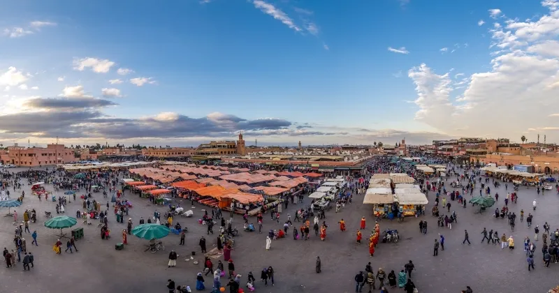 A vibrant market Marrakech Morocco , showcasing colorful stalls and bustling activity among locals and tourists.