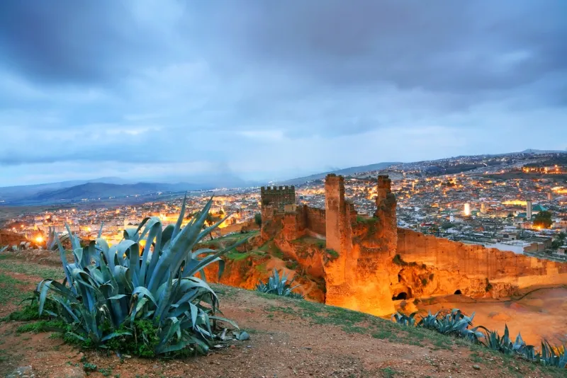 Morocco at dusk, showcasing the city's skyline and warm evening hues, ideal for travel exploration.