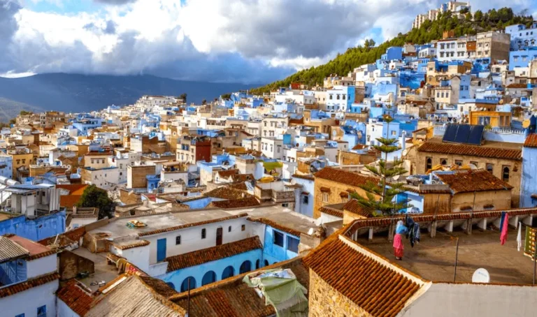 Scenic view of Chefchaouen, Morocco, showcasing its iconic blue buildings and mountainous backdrop, ideal for tour packages.