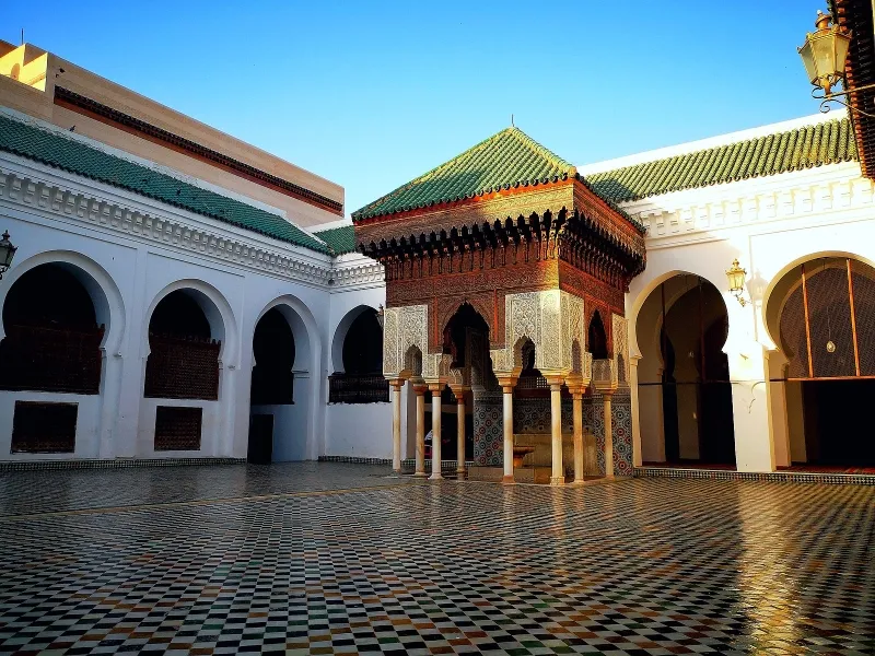 A courtyard featuring a lush green roof, showcasing an attraction in Fes, Morocco.