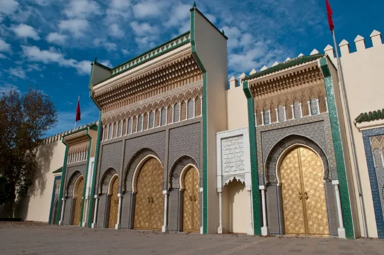Entrance to the Sultan's palace in Fes, Morocco, showcasing intricate architecture and vibrant colors.