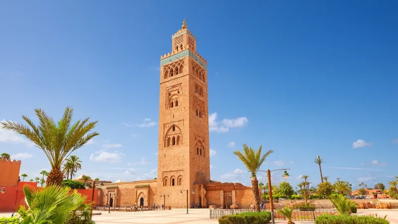 Islamic mosque in Morocco, showcasing intricate architecture, set against a backdrop of the desert landscape.