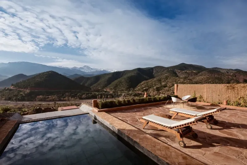 The pool at the Atlas Mountains resort, surrounded by scenic views of the Ourika Valley.