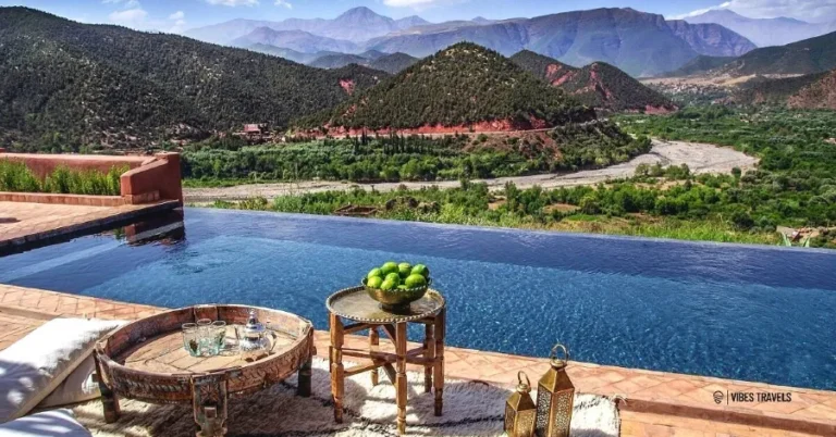 A serene pool overlooking the mountains of Ourika Valley, showcasing a stunning mountain range in the background.