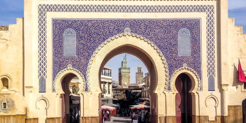 The entrance to Marrakesh, showcasing traditional Moroccan architecture and vibrant colors, inviting visitors to explore.