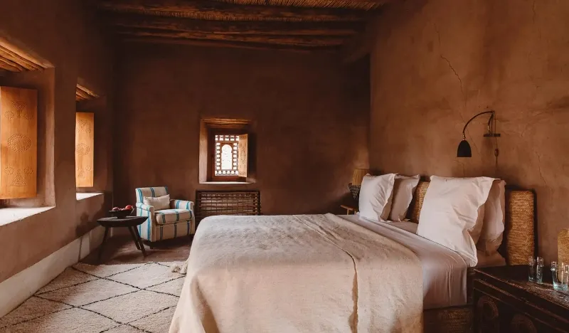 A cozy bedroom featuring a bed and a window, inviting natural light into the space.