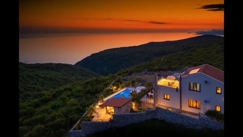 A house illuminated at sunset, with the ocean in the background, showcasing the beauty of the Sahara's majesty and highlighting what is Morocco known for