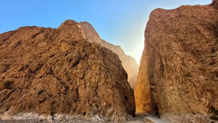 A view of the narrowest road in the world, located in the stunning Todra Gorge, surrounded by towering rock formations.