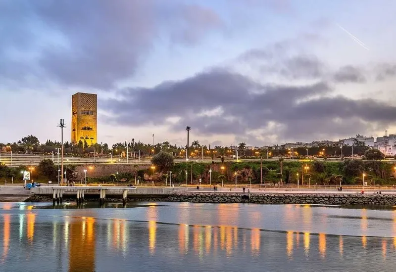featuring a panoramic view of its skyline bathed in warm evening light.